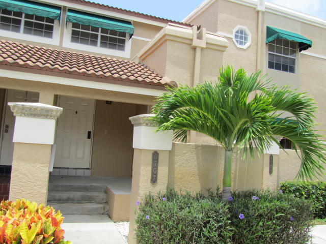 a front view of a house with plants