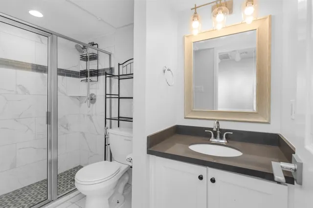 a bathroom with a sink toilet and shower