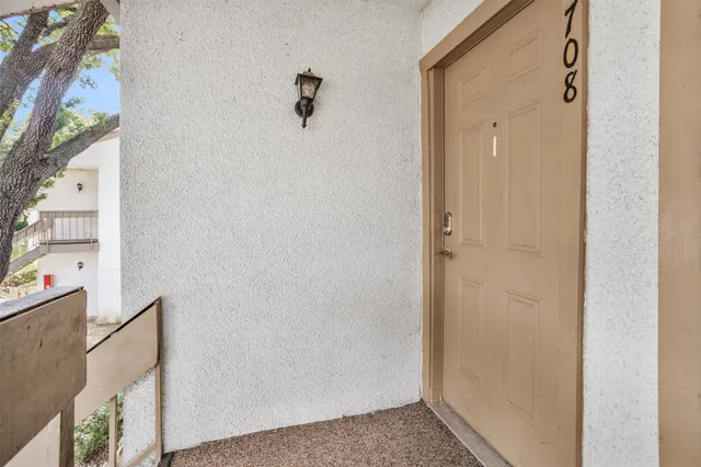 a view of a patio with a table and chairs