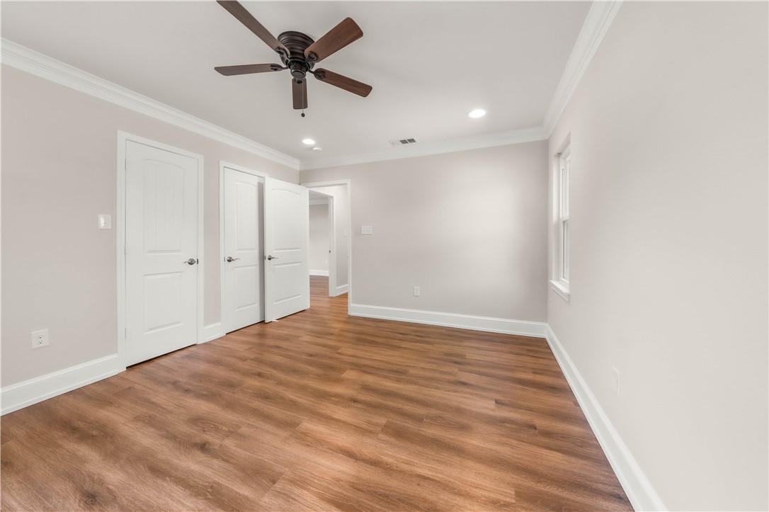 3405 MacArthur Drive Waco, TX 76708 - Photo 12 of 83 a view of a big room with wooden floor and a chandelier fan