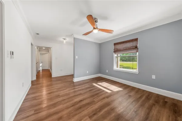 a view of a hallway with wooden floor and closet