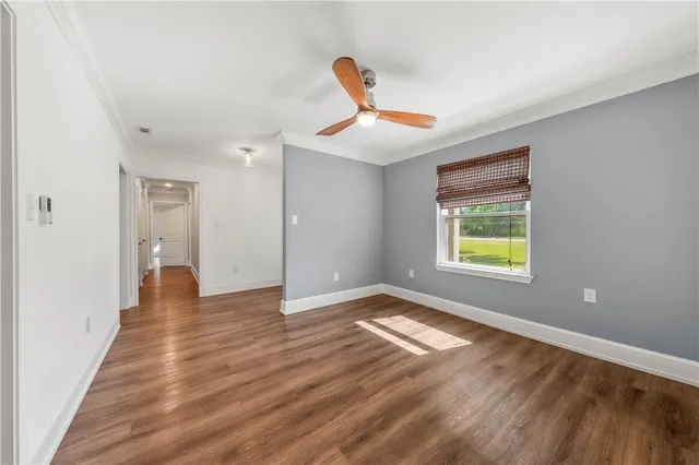 a view of a hallway with wooden floor and closet