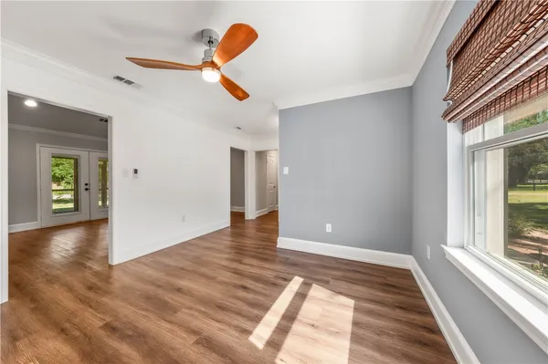 a view of a hallway with wooden floor and closet