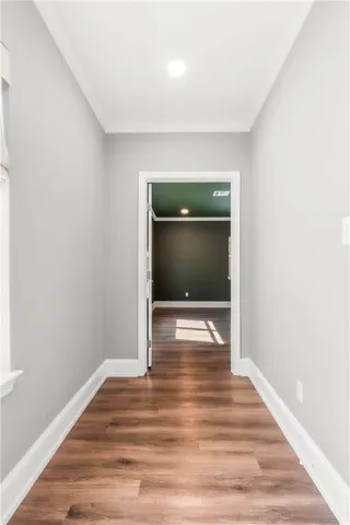 a view of a room with a large window and ceiling fan