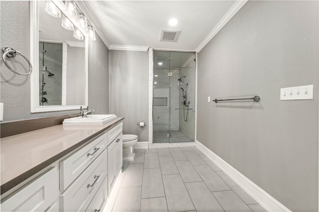 3405 MacArthur Drive Waco, TX 76708 - Photo 39 of 83 a bathroom with a shower sink and mirror