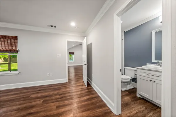 a view of a house with a yard and potted plants