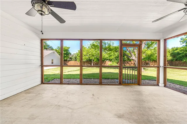 a view of a house with a yard and large trees
