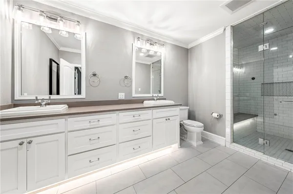 an empty room with wooden floor ceiling fan and windows