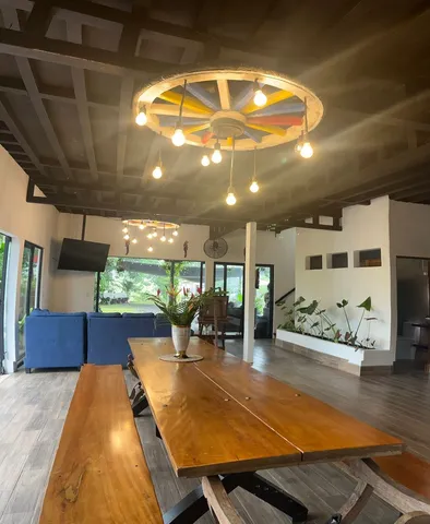 a dining room with furniture and a floor to ceiling window