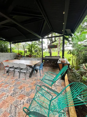 a view of an outdoor sitting area with couch and umbrella