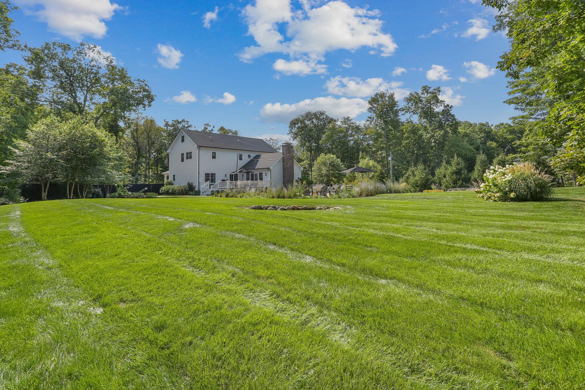 46 Blueberry Hill Road Redding, CT 06896 - Photo 30 of 32 a view of a big room with a big yard and large trees