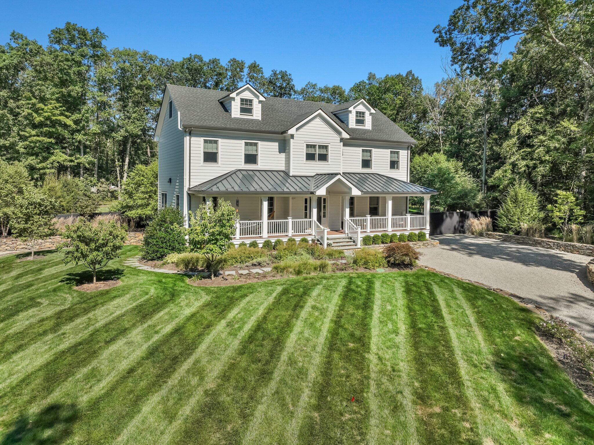 46 Blueberry Hill Road Redding, CT 06896 - Photo 31 of 32 a front view of a residential apartment building with a yard