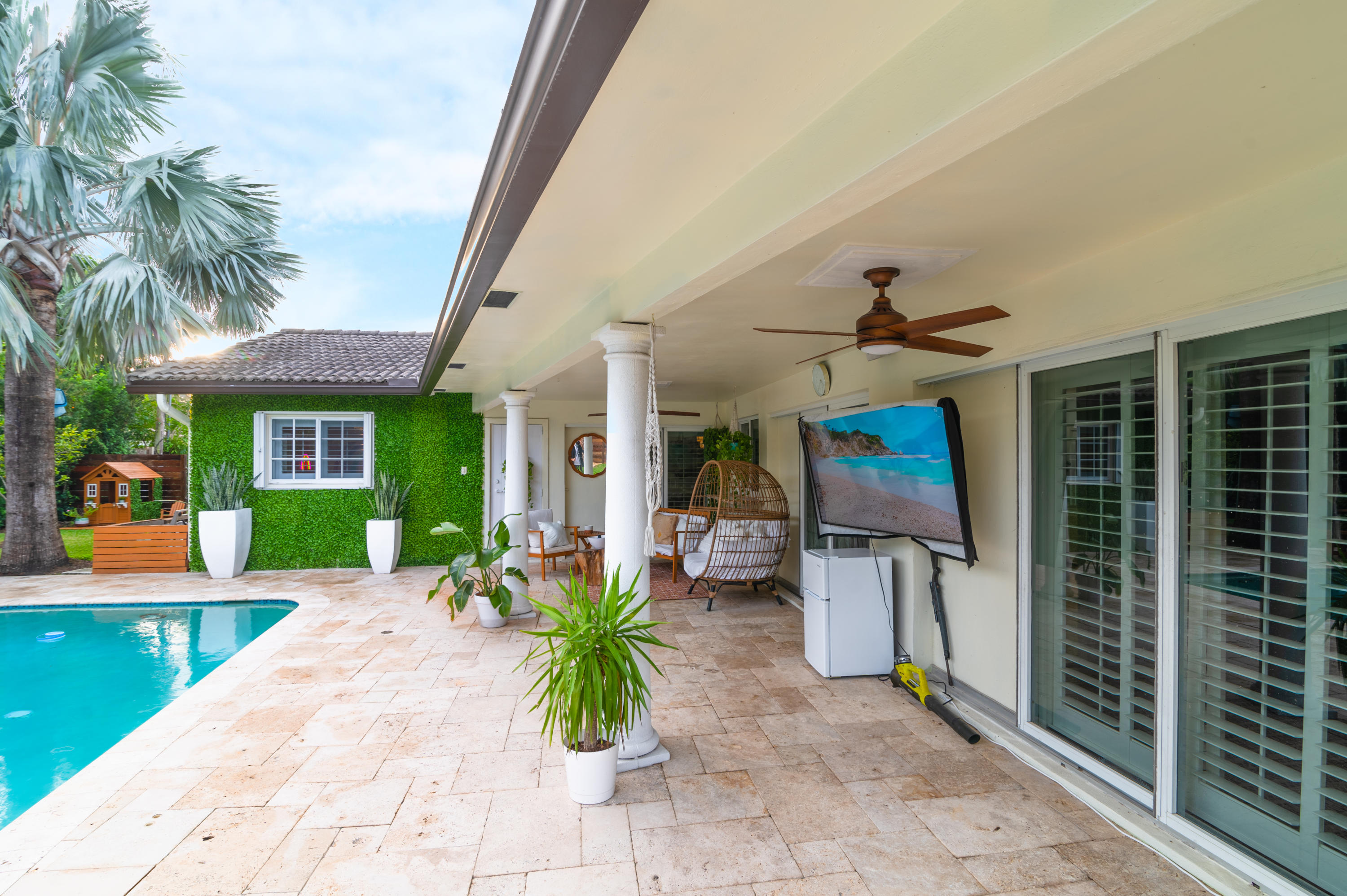 a view of a house with backyard porch and sitting area