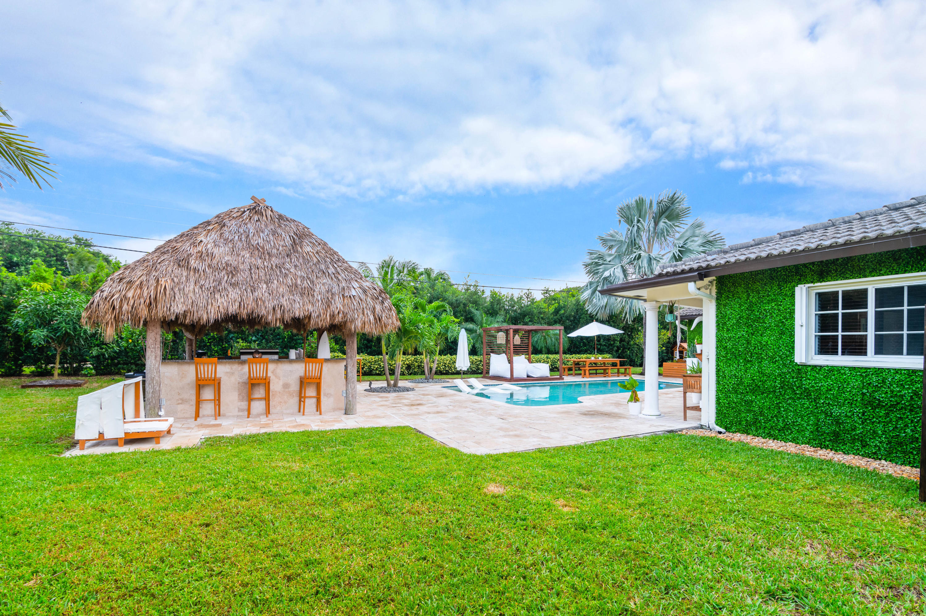 1502 Northwest 5th Street Boca Raton, FL 33486 - Photo 11 of 35 a view of a house with a backyard and a patio