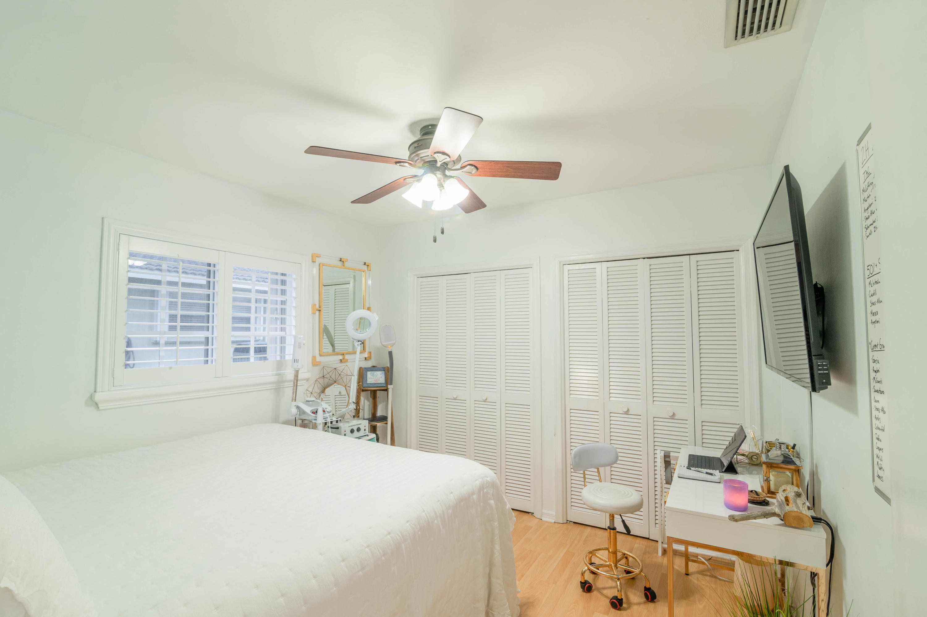 1502 Northwest 5th Street Boca Raton, FL 33486 - Photo 30 of 35 a bedroom with a bed and a chandelier