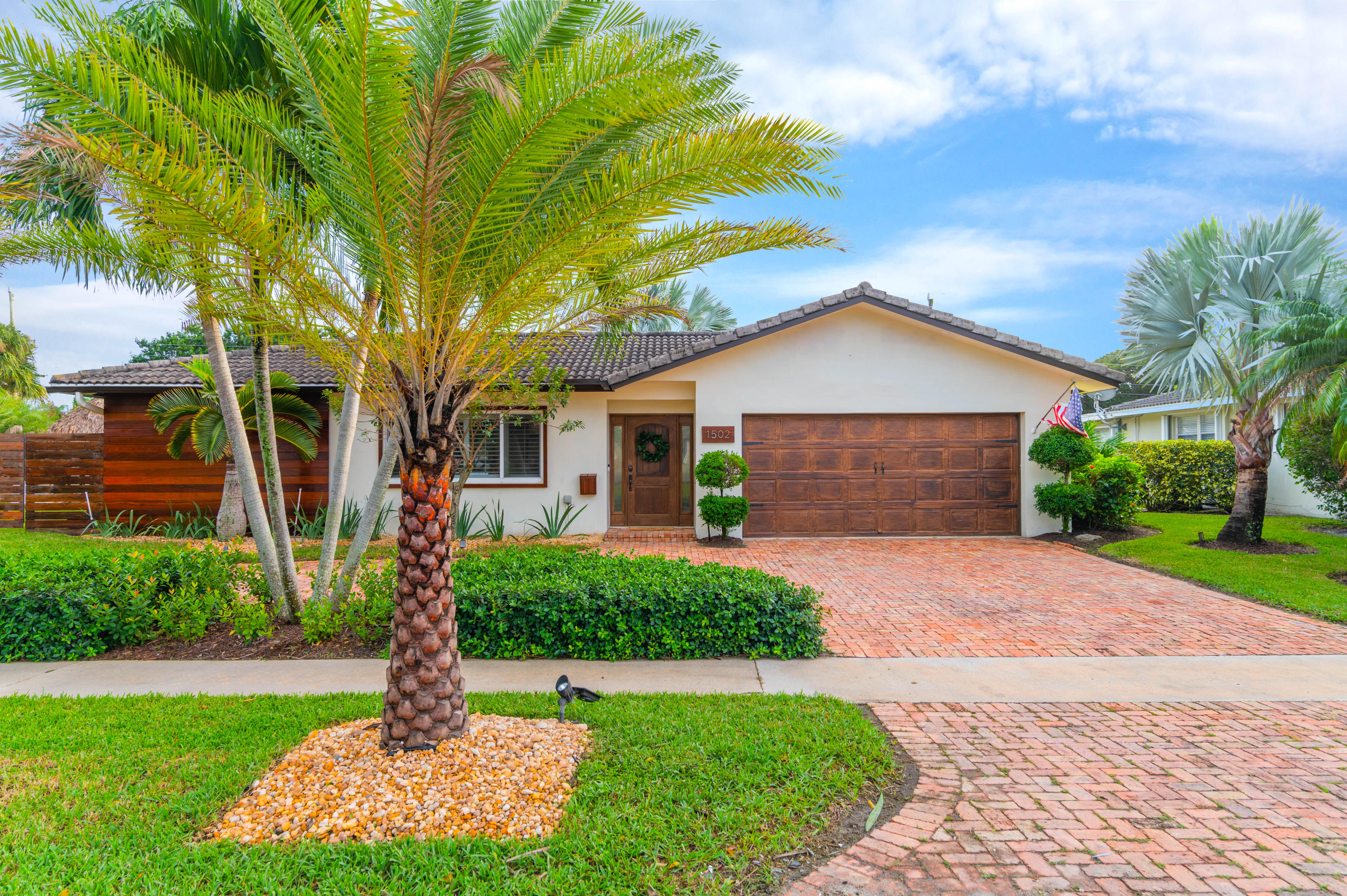 1502 Northwest 5th Street Boca Raton, FL 33486 - Photo 3 of 35 a front view of a house with garden