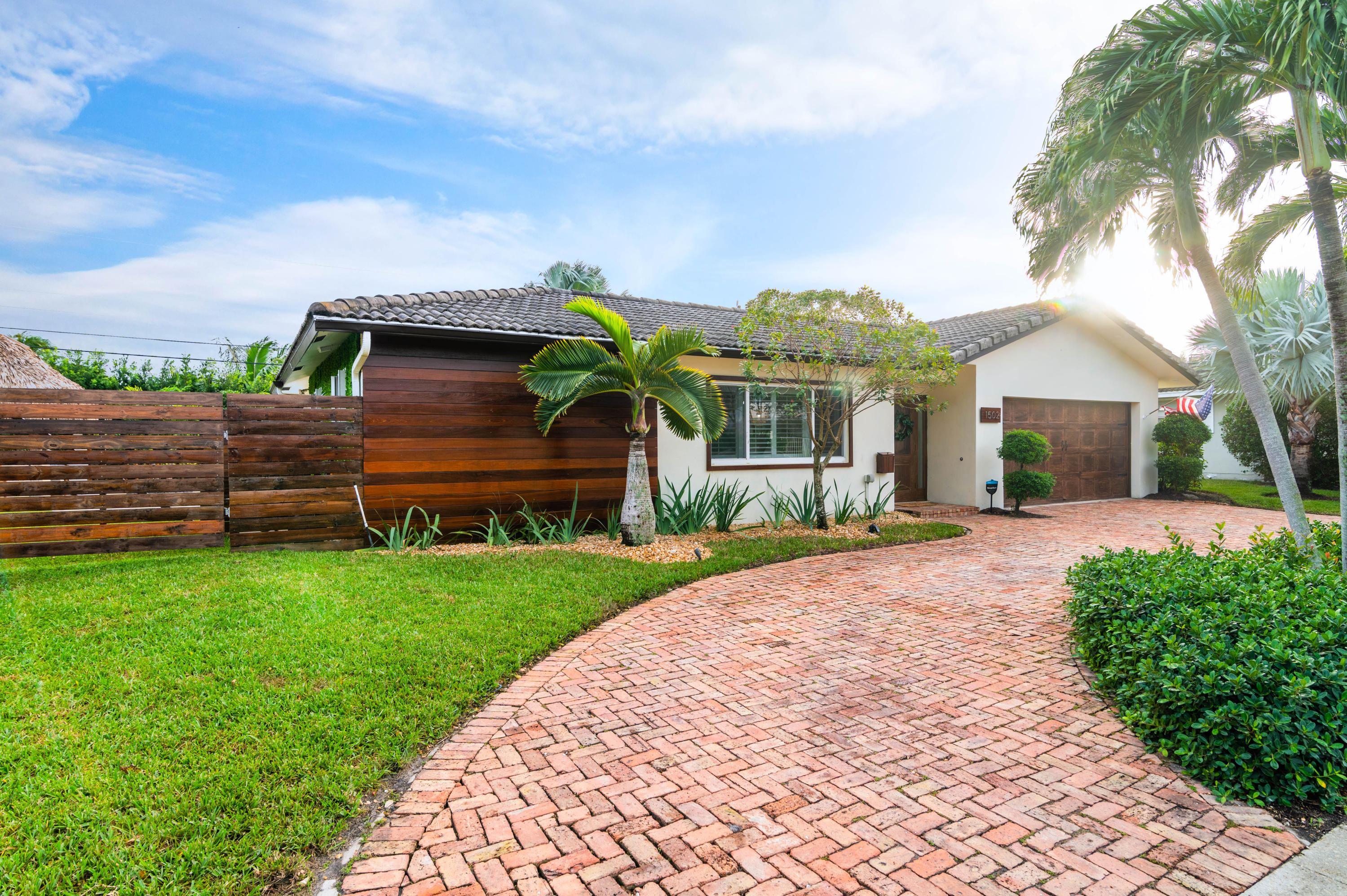 1502 Northwest 5th Street Boca Raton, FL 33486 - Photo 4 of 35 a front view of a house with a yard