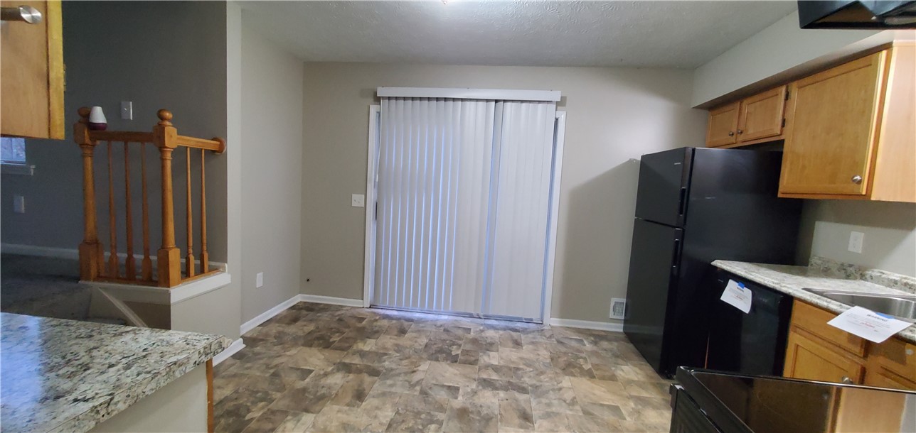 79 Eastview Commons Road Gates, NY 14624 - Photo 9 of 32 Kitchen with Sliding Glass door to back patio