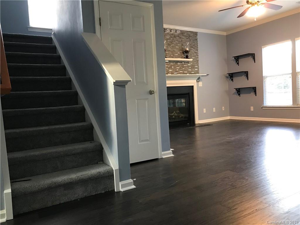 609 Eaton Court Fort Mill, SC 29708 - Photo 11 of 24 a view of a livingroom with wooden floor and a kitchen space