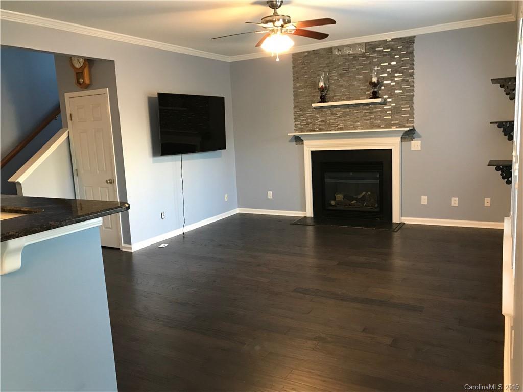 609 Eaton Court Fort Mill, SC 29708 - Photo 12 of 24 a view of a livingroom with an empty space and a fireplace