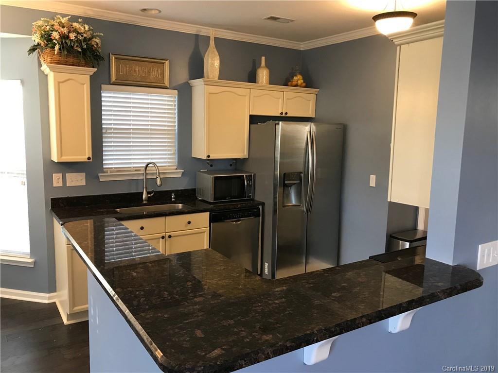 609 Eaton Court Fort Mill, SC 29708 - Photo 15 of 24 a kitchen with stainless steel appliances granite countertop a sink a stove and a refrigerator