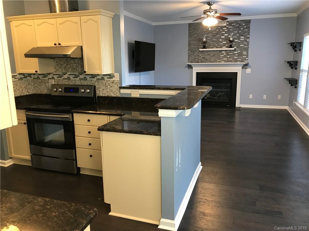 609 Eaton Court Fort Mill, SC 29708 - Photo 16 of 24 a kitchen with stainless steel appliances granite countertop a stove and a wooden cabinets