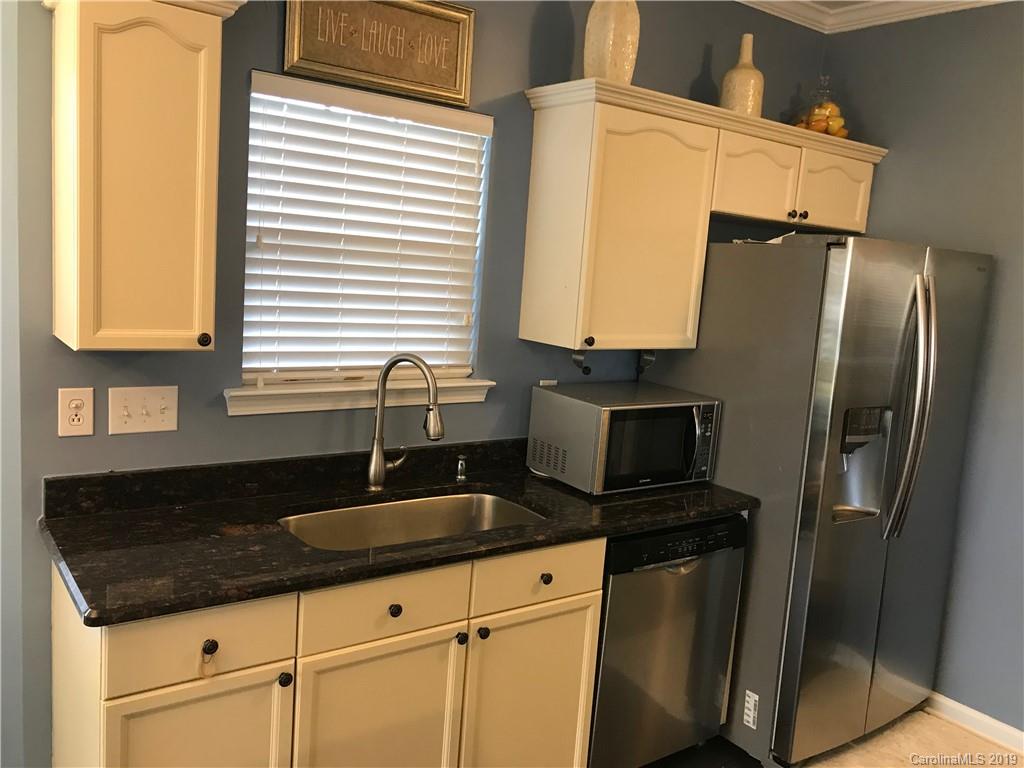609 Eaton Court Fort Mill, SC 29708 - Photo 17 of 24 a kitchen with granite countertop a sink stainless steel appliances and cabinets