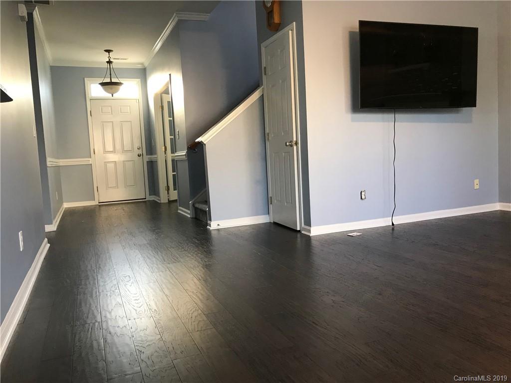 609 Eaton Court Fort Mill, SC 29708 - Photo 9 of 24 a view of a livingroom with wooden floor and stairs