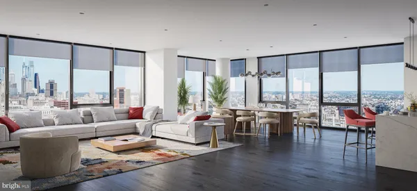 a living room with furniture large windows and wooden floor