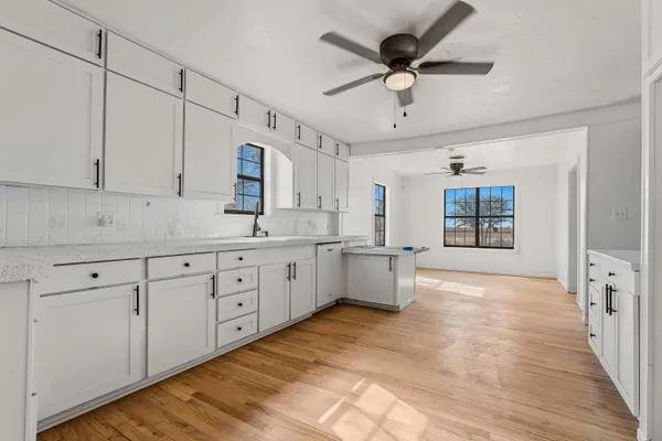 a kitchen with granite countertop a sink cabinets stainless steel appliances and a counter space