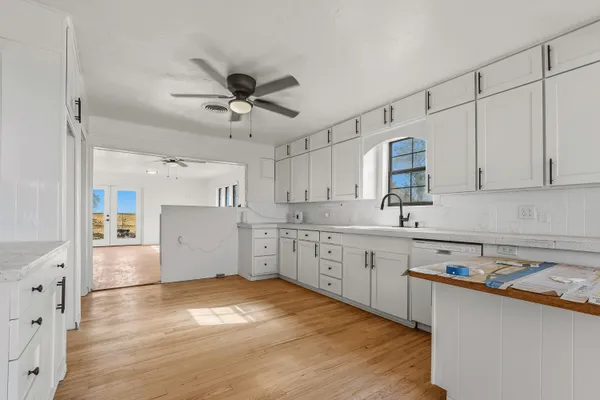 a view of empty room with fireplace and wooden floor