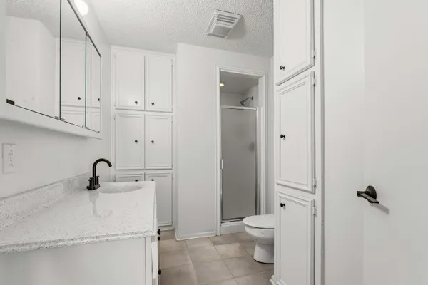 an empty room with a ceiling fan and wooden floor