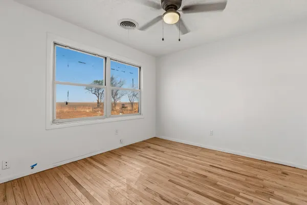 a view of a room with wooden floor
