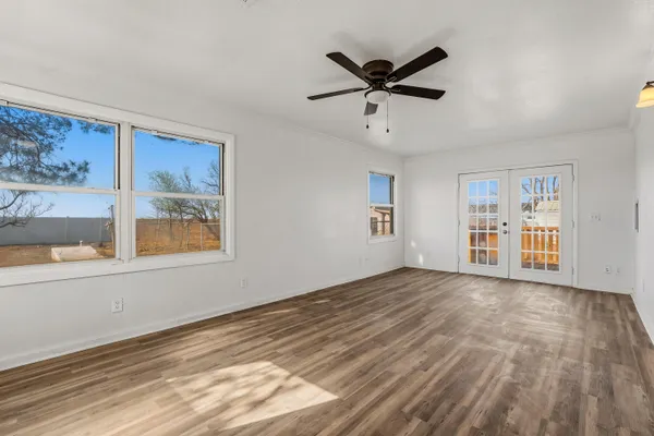 a view of empty room with wooden floor