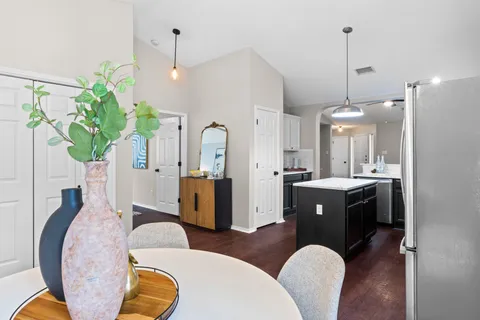 a view of living room filled with furniture and a chandelier