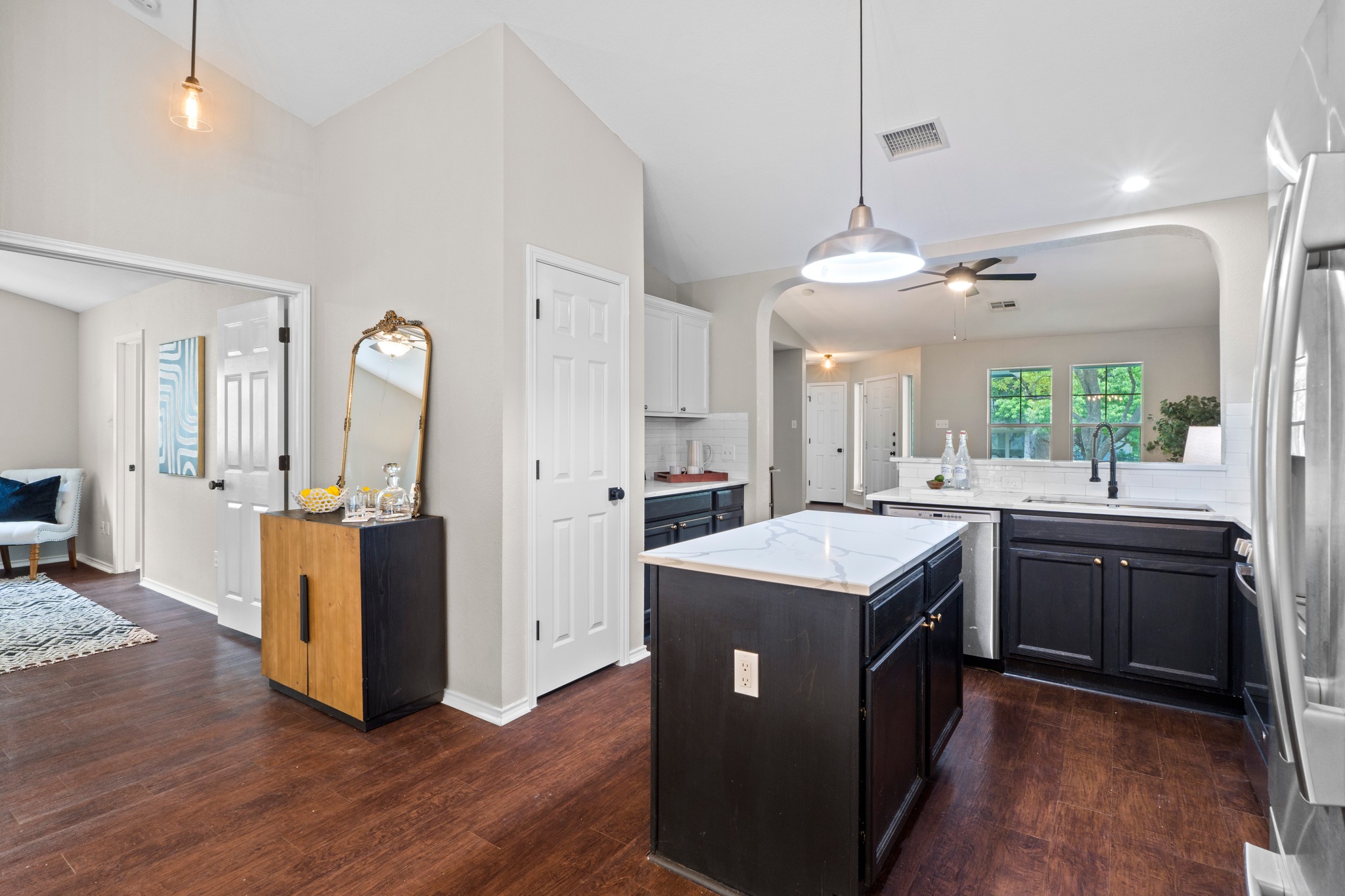1042 Monadale Trail Round Rock, TX 78664 - Photo 19 of 40 a kitchen with a stove a refrigerator a sink dishwasher with a dining table and chairs