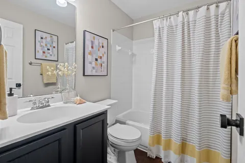 a bathroom with a sink a toilet and mirror