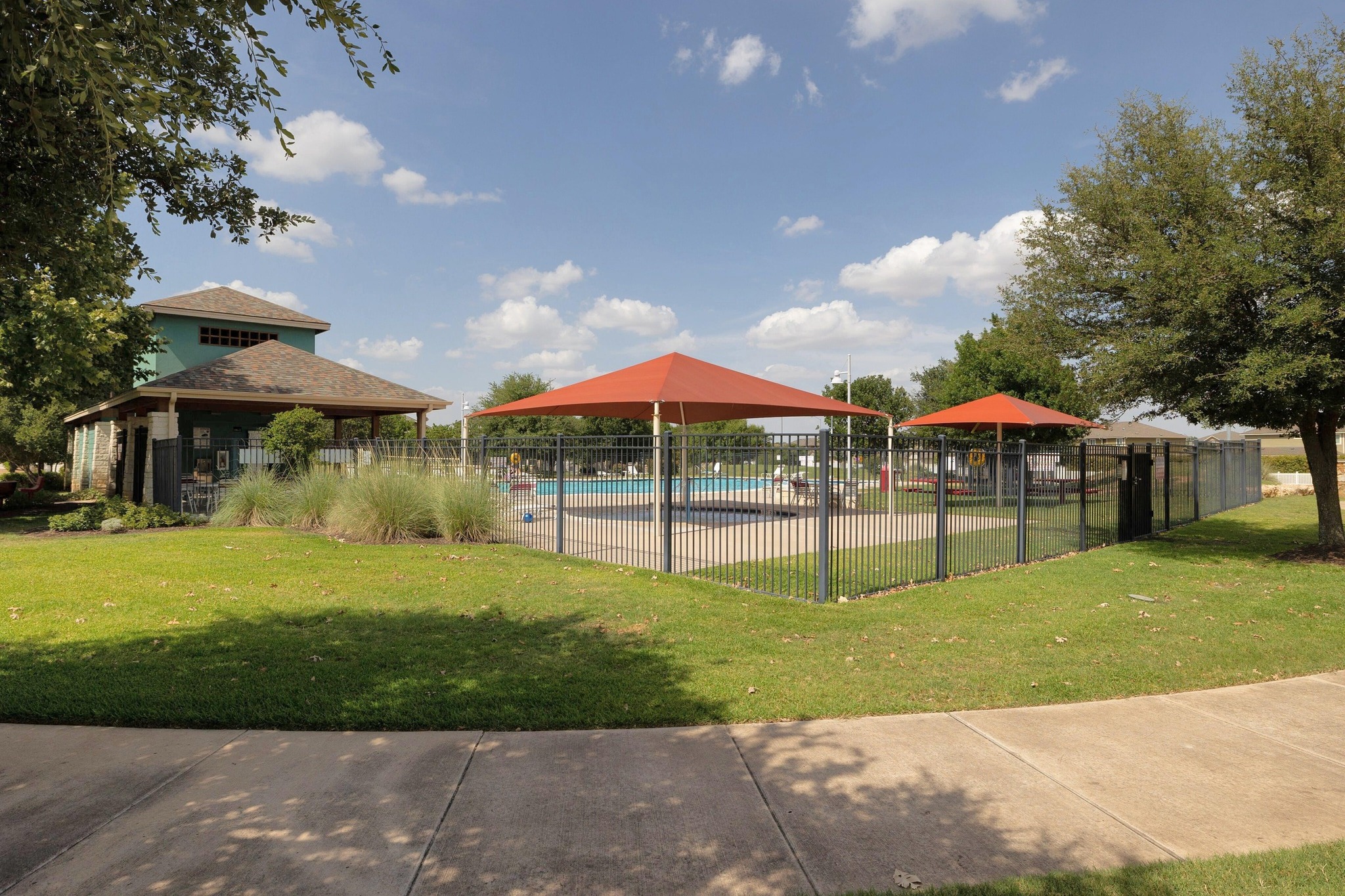1042 Monadale Trail Round Rock, TX 78664 - Photo 35 of 40 a view of pool with table and chairs under an umbrella