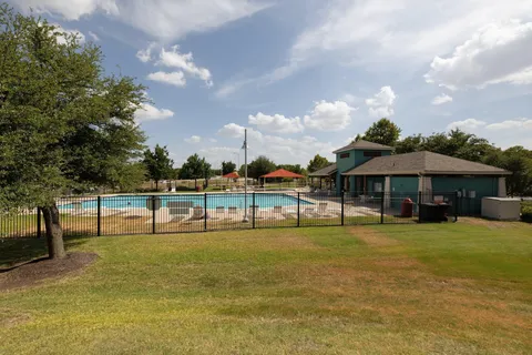 a view of a swimming pool with a table and chairs