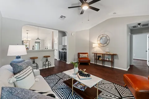 a living room with furniture and wooden floor