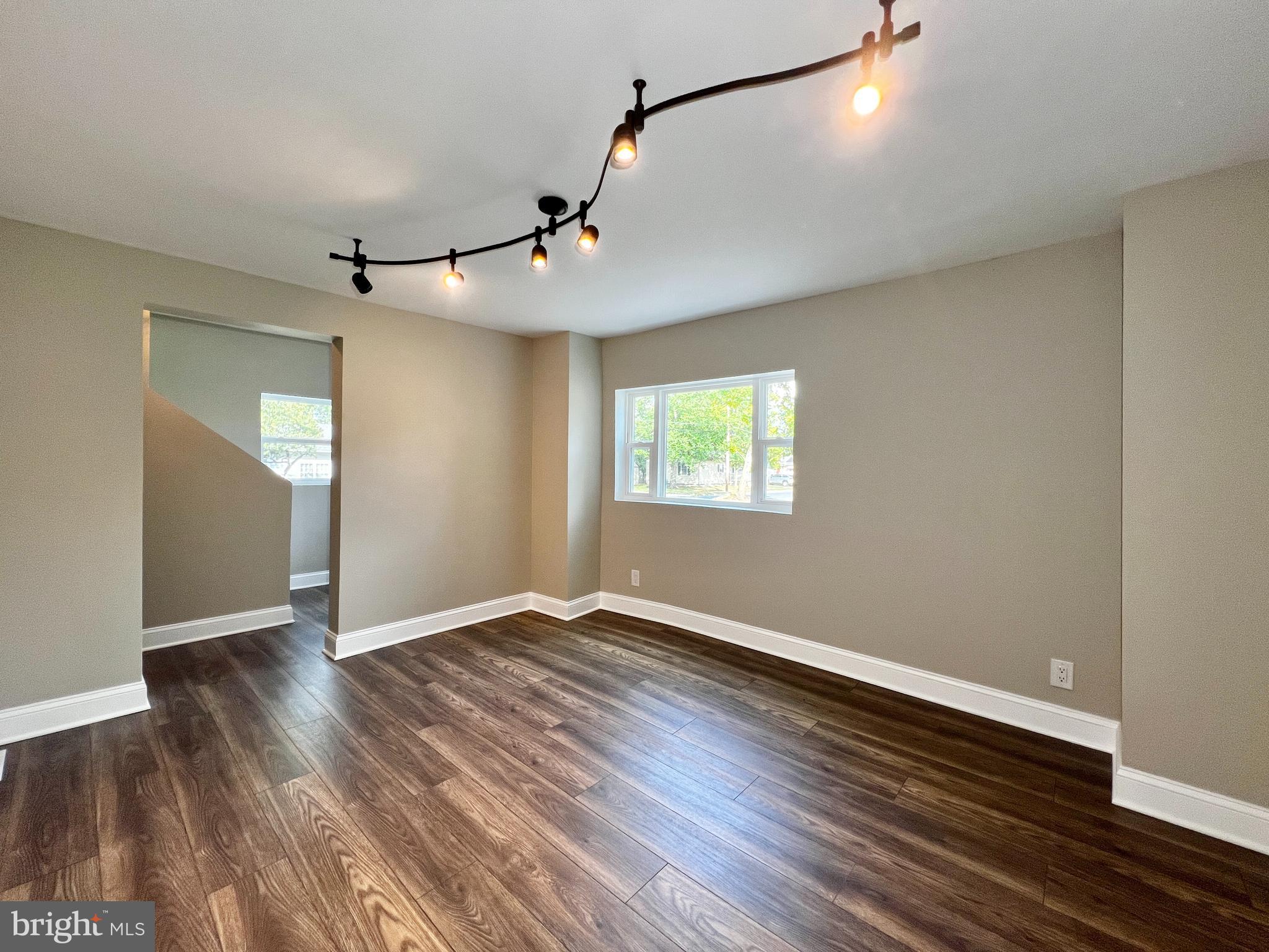 516 10th Avenue Lindenwold, NJ 08021 - Photo 2 of 22 an empty room with wooden floor and windows