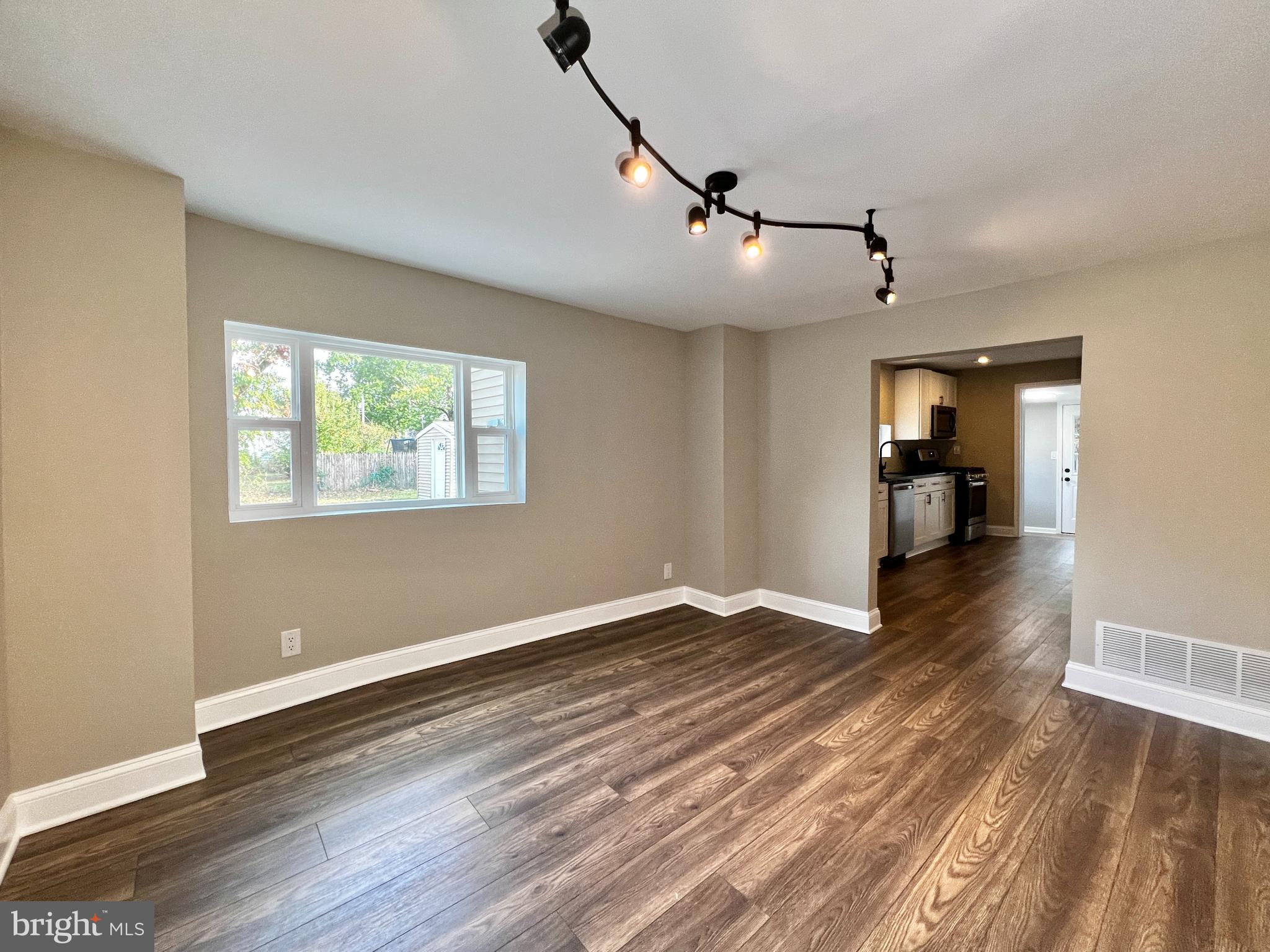 516 10th Avenue Lindenwold, NJ 08021 - Photo 3 of 22 a view of empty room with wooden floor and fan