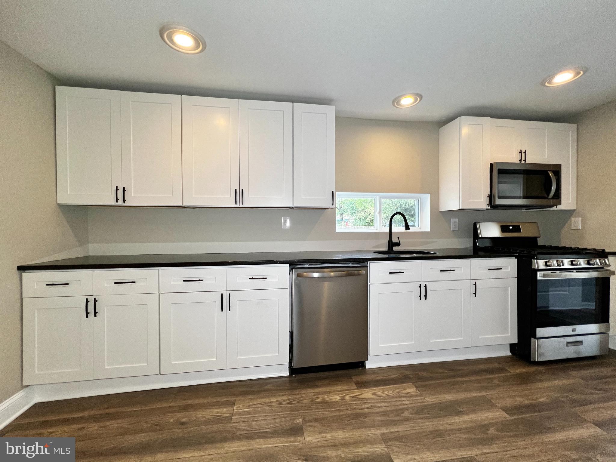 516 10th Avenue Lindenwold, NJ 08021 - Photo 5 of 22 a kitchen with granite countertop white cabinets and stainless steel appliances