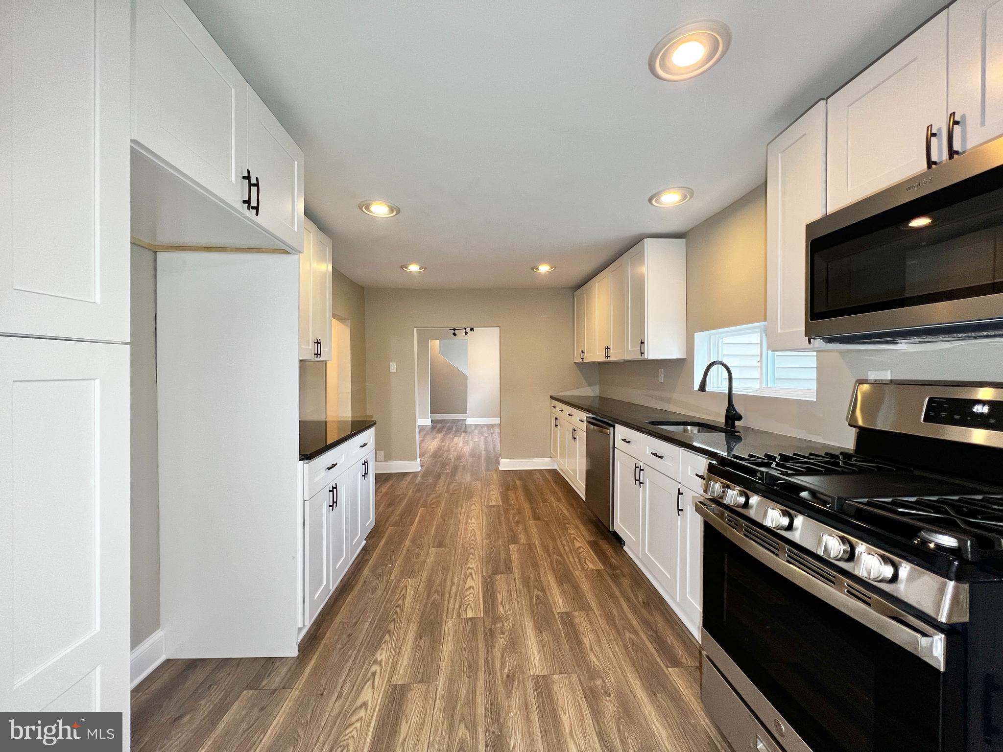 516 10th Avenue Lindenwold, NJ 08021 - Photo 8 of 22 a large kitchen with stainless steel appliances