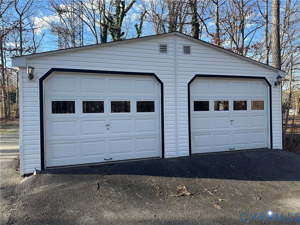 10510 Courtney Road Glen Allen, VA 23060 - Photo 20 of 32 a view of a white house with a large space in front of it