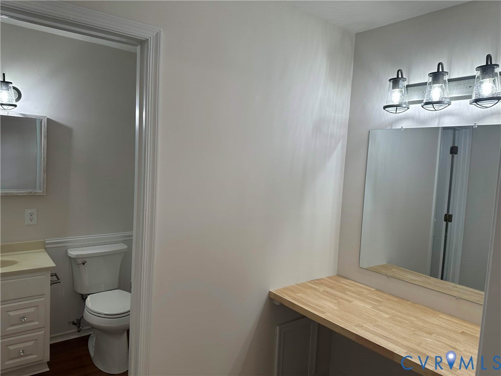 10510 Courtney Road Glen Allen, VA 23060 - Photo 31 of 32 a bathroom with a granite countertop sink toilet and a mirror