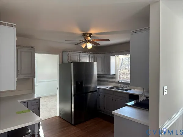 a kitchen with a refrigerator and a stove top oven