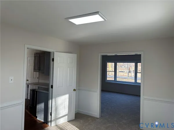 an empty room with windows and closet