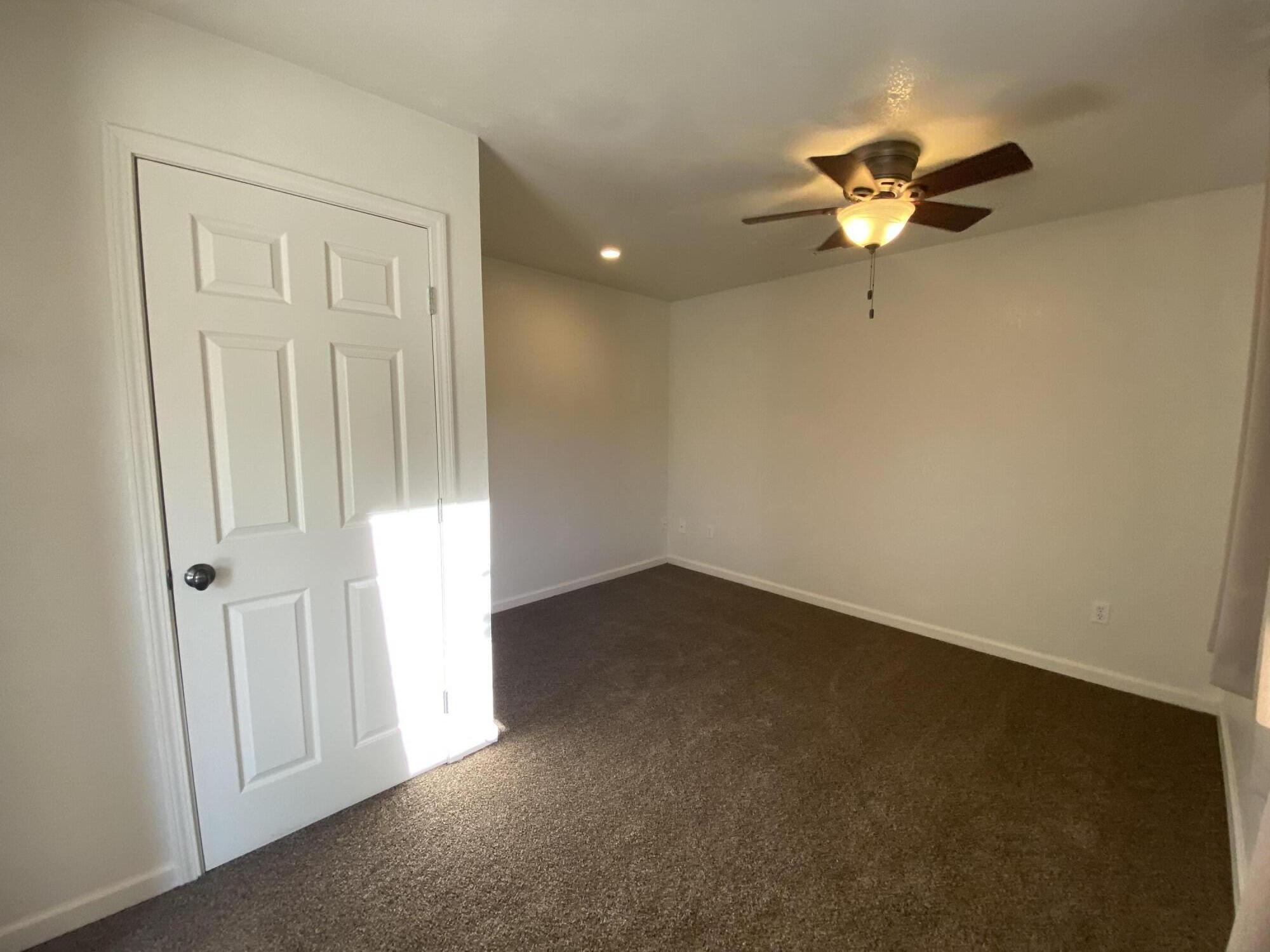 40855 Grouse Drive Three Rivers, CA 93271 - Photo 19 of 24 an empty room with a chandelier fan and wooden floor