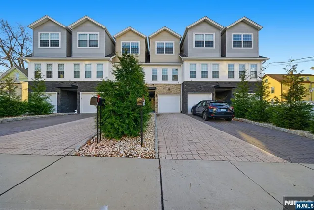 a car parked in front of a white house